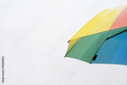 Close up of colorful umbrella part with raindrops