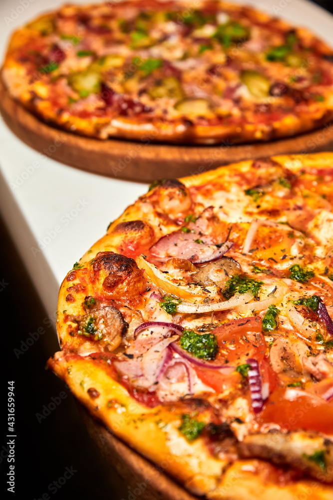 Fresh pizza with bacon, mushrooms and cheese on a light background. Close-up, selective focus Fresh pizza with bacon, mushrooms and cheese on a light background. Close-up, selective focus