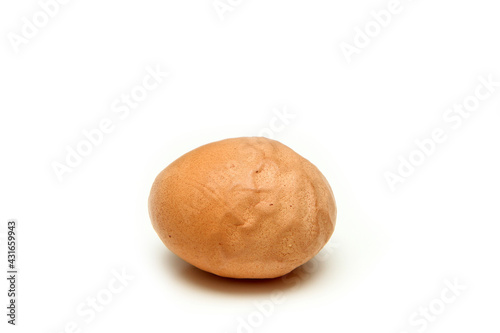 The organic egg with rough and wavy eggshell. Isolated on white background. Reason can be the old hen  insufficient nutrition or wrong process of formation of the egg. 