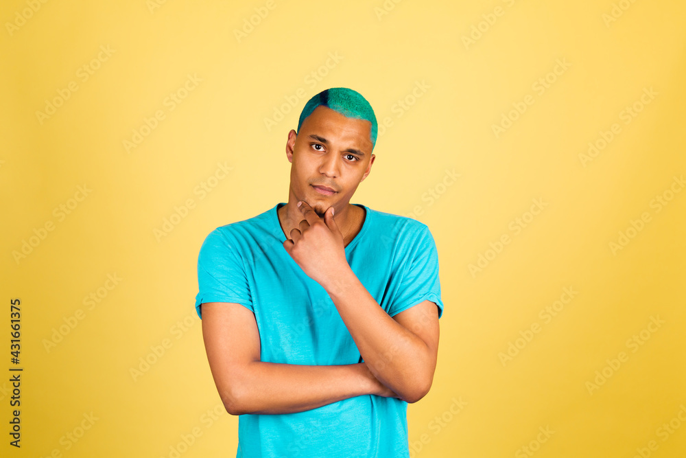 Black african man in casual on yellow background look to camera, thoughtful hold chin thinking Black african man in casual on yellow background look to camera, thoughtful hold chin thinking