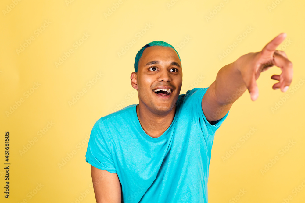 Black african man in casual on yellow background happy positive cheerful excited pointer finger to right far away Black african man in casual on yellow background happy positive cheerful excited pointer finger to right far away