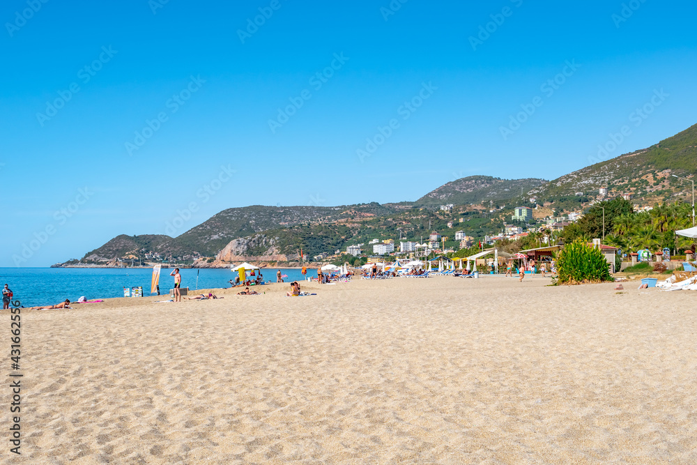 Alanya, Turkey - October 23, 2020: Beautiful landscape of Kleopatra Beach in Alanya with clean white sand against the backdrop of azure water and green mountains