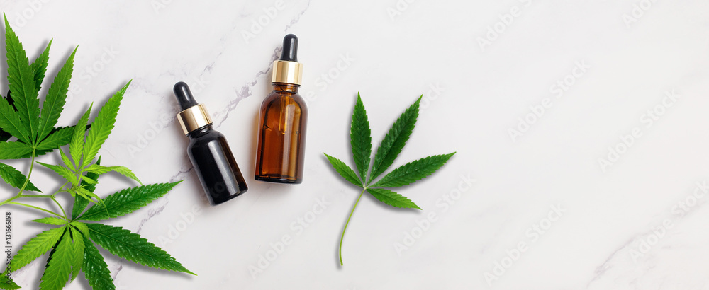 Organic Spa Cosmetic With Herbal cannabis ingredients. Serum with herbal extracts for skincare concept. Droppers with cannabis leafs on marble background. Top view, flat lay, banner Organic Spa Cosmetic With Herbal cannabis ingredients. Serum with herbal extracts for skincare concept. Droppers with cannabis leafs on marble background. Top view, flat lay, banner