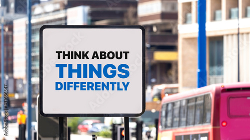 Think About Things Differently sign in a busy city centre
