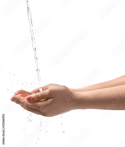 Pouring water into woman's hands on grey background, closeup