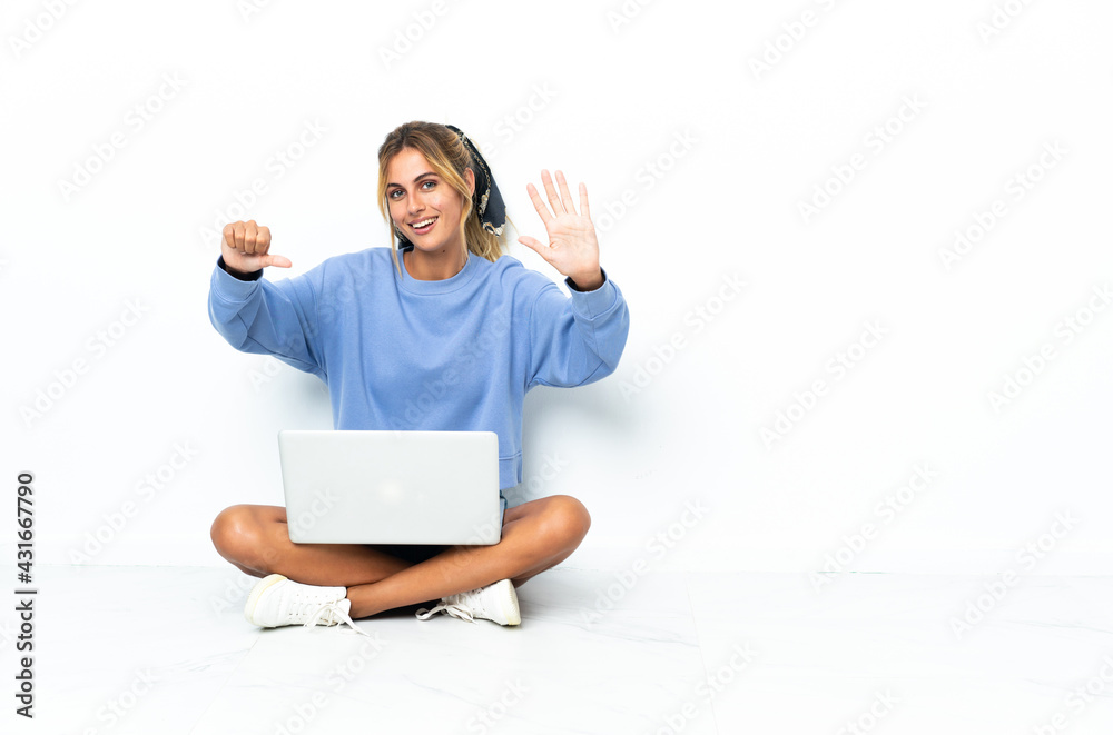 Young blonde Uruguayan girl with the laptop isolated on white background counting six with fingers Young blonde Uruguayan girl with the laptop isolated on white background counting six with fingers