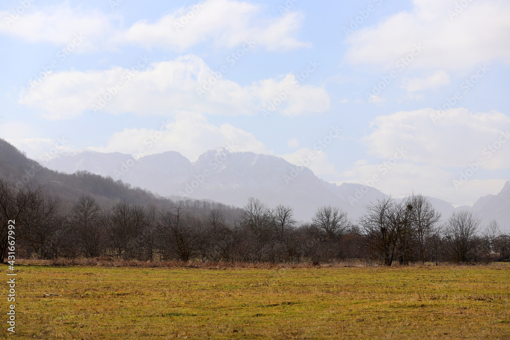 Beautiful dry field with mountains silhouettes.