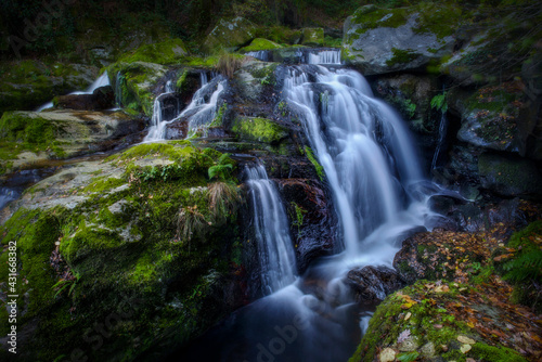 small waterfall in a Galician forest, long exposure photo
