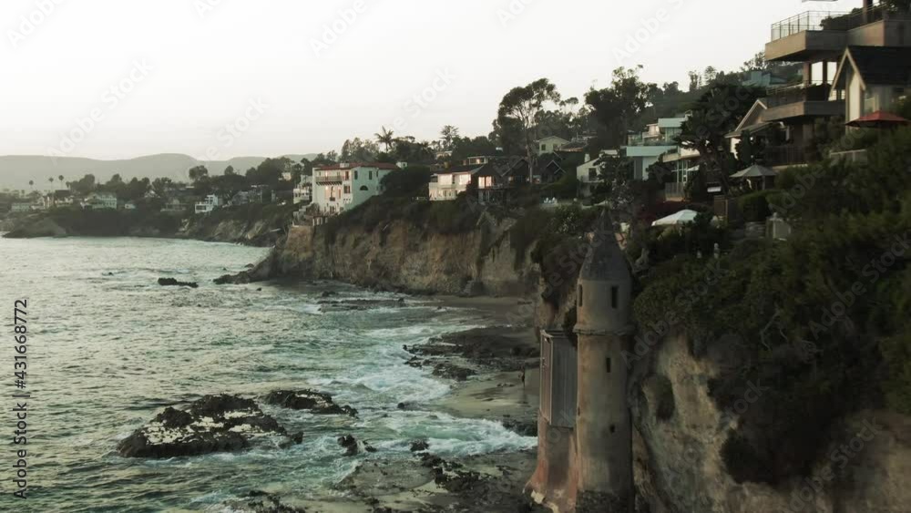 Aerial Shot Of Waves Splashing At Famous Pirate Tower By Cliff, Drone Flying Over Coastal City Against Sky - Los Angeles, California Aerial Shot Of Waves Splashing At Famous Pirate Tower By Cliff, Drone Flying Over Coastal City Against Sky - Los Angeles, California