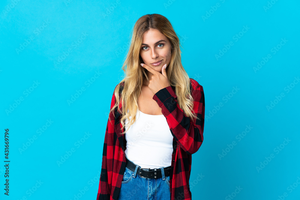 Young blonde Uruguayan woman over isolated background thinking
