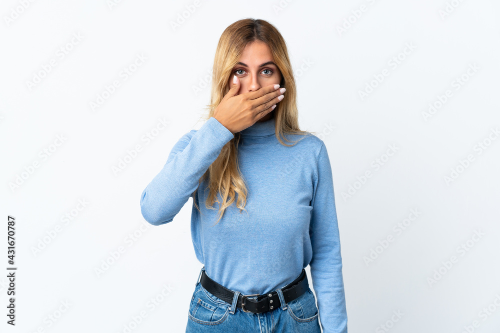 Young blonde Uruguayan woman over isolated background covering mouth with hand Young blonde Uruguayan woman over isolated background covering mouth with hand