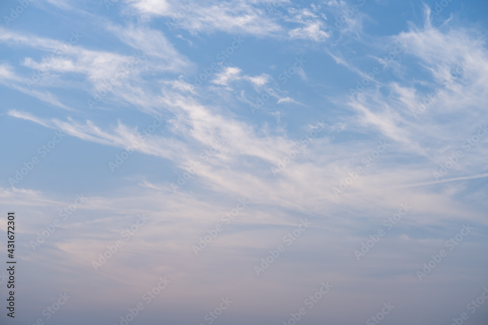 White clouds against blue sky in horizontal background and copy space