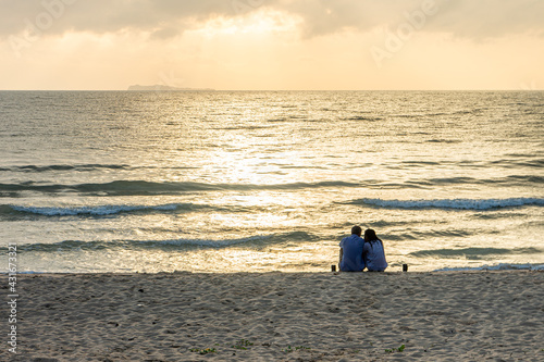 Romantic couple on Thung Wua Laen beach at sunrise. Scenery in Chumphon province  Southern Thailand.