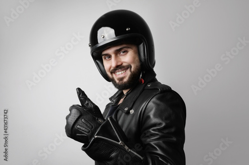 Headshot of happy biker man, posing on the white background.