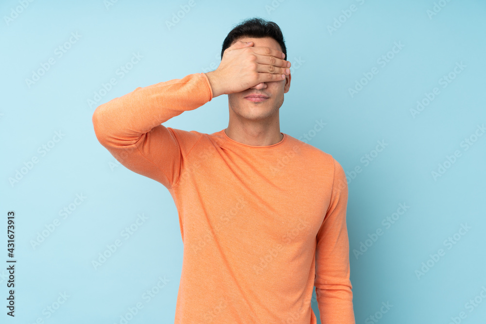 Young caucasian handsome man isolated on blue background covering eyes by hands. Do not want to see something Young caucasian handsome man isolated on blue background covering eyes by hands. Do not want to see something