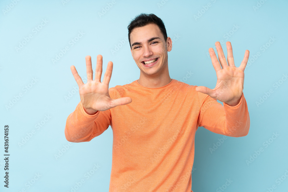 Young caucasian handsome man isolated on blue background counting ten with fingers Young caucasian handsome man isolated on blue background counting ten with fingers