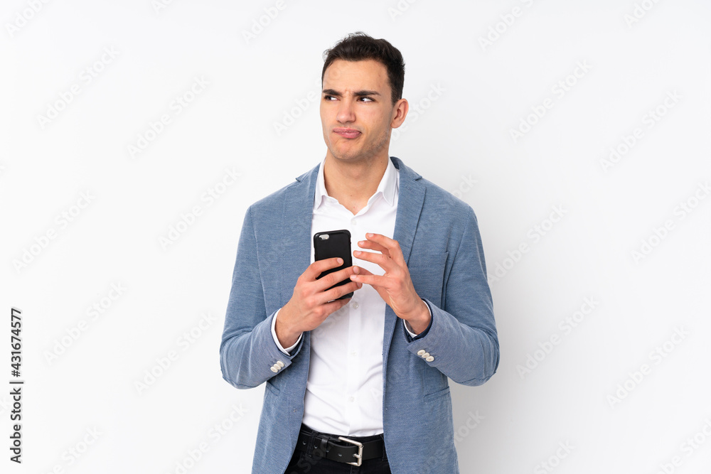 Young handsome businessman on isolated background scheming something Young handsome businessman on isolated background scheming something