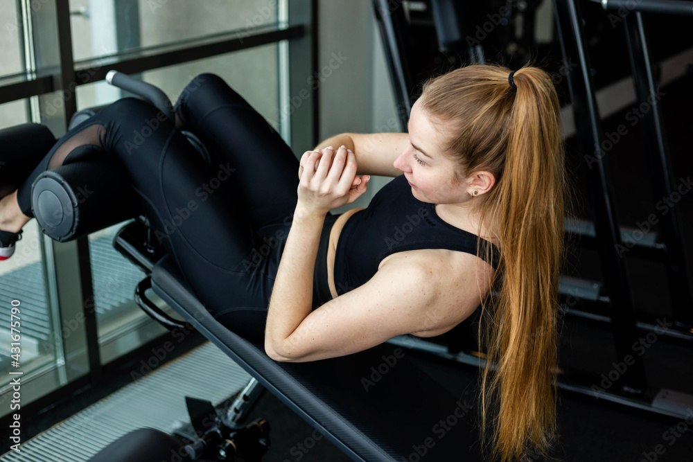 Young attractive girl in sportswear in a fitness club. Sports concept.
