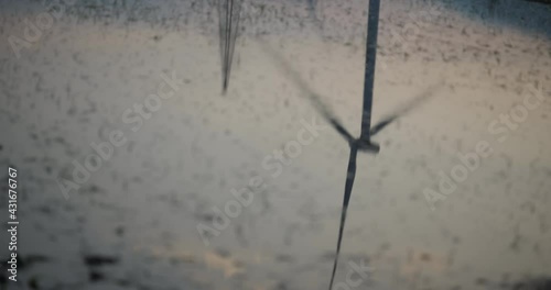 Refelcetion of a wind turbine in a Chinese farm located in the valley of Sichuan located in between traditional chinese farms photo