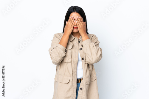 Young latin woman woman isolated on white background covering eyes by hands
