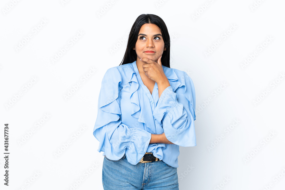 Young latin woman woman isolated on white background thinking an idea while looking up Young latin woman woman isolated on white background thinking an idea while looking up