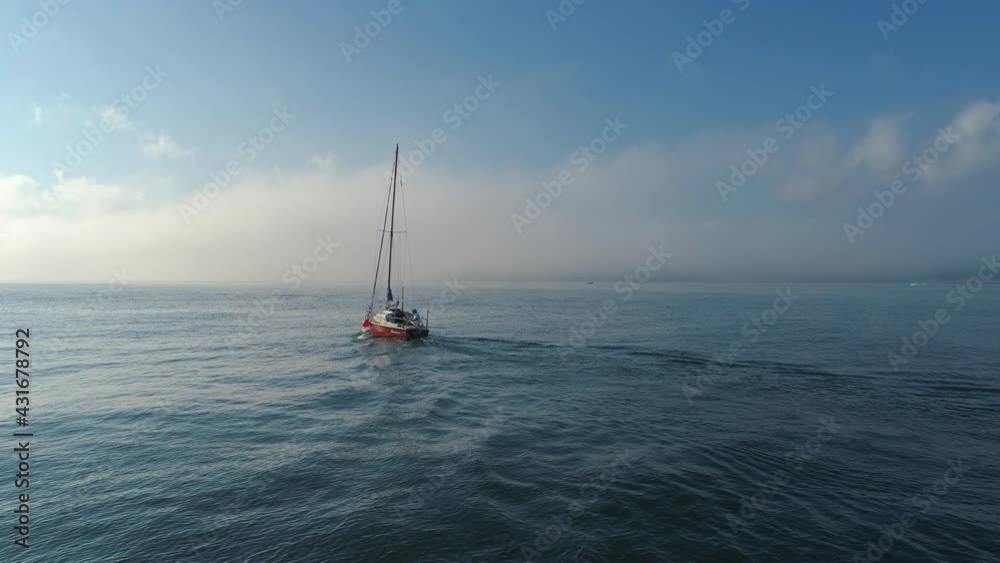 Sailboat sailing in the blue sea, aerial 4k sunrise video Sailboat sailing in the blue sea, aerial 4k sunrise video
