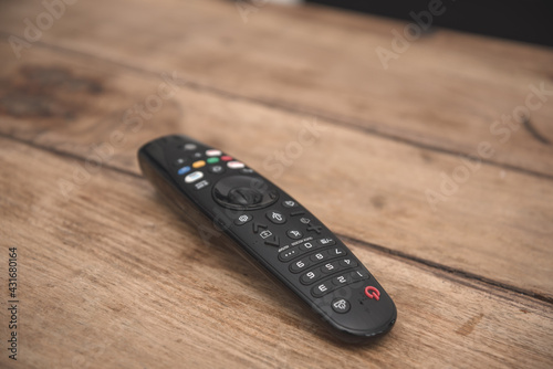 TV remote control isolated on wooden coffee table