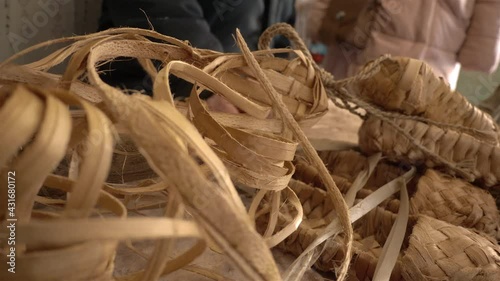 The village master weaves bast shoes.