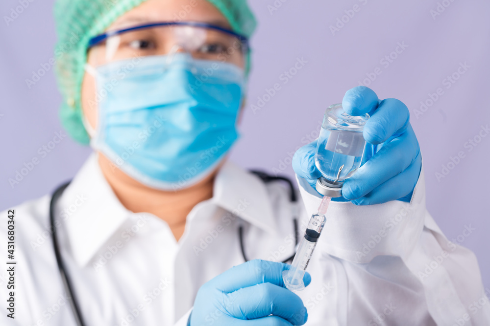 Doctor with a stethoscope on shoulder holding syringe and COVID-19 vaccine. Healthcare And Medical concept. Discovery Healing and End of Pandemic Living with COVID 19 Vaccine . Coronavirus Vaccine. Doctor with a stethoscope on shoulder holding syringe and COVID-19 vaccine. Healthcare And Medical concept. Discovery Healing and End of Pandemic Living with COVID 19 Vaccine . Coronavirus Vaccine.