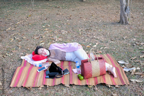 One young woman sleep on the mat with accessories