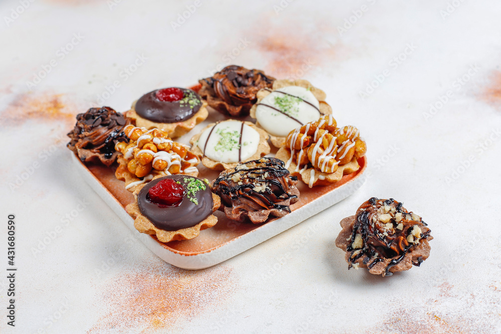 Various homemade mini tartlets with nuts and chocolate cream.