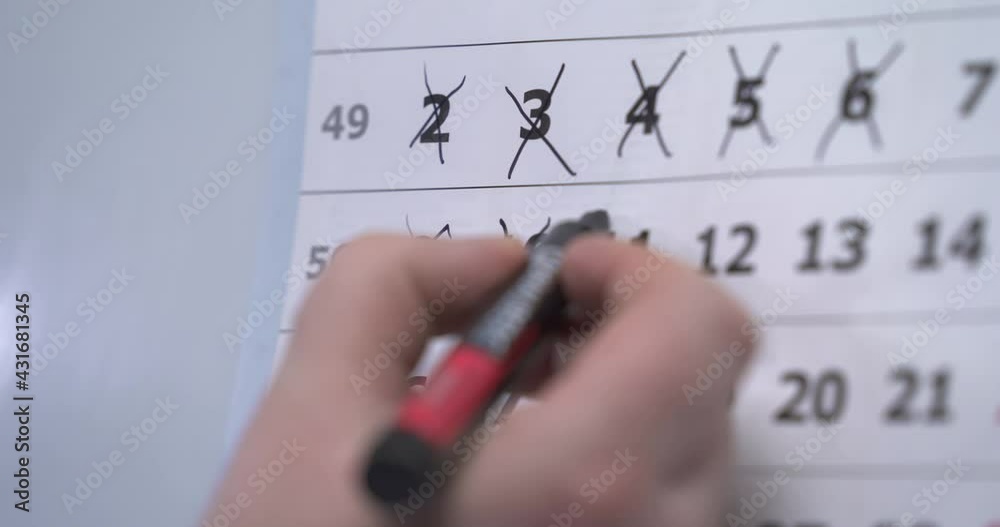 The hand circles the weekend days on the calendar. the hand sticks a reminder on the calendar about the meeting. meeting. an important event. reminder card. Closeup on a calendar with DAY OFF being