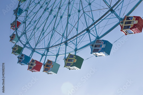 Classic Ferris wheel on blue sky background.