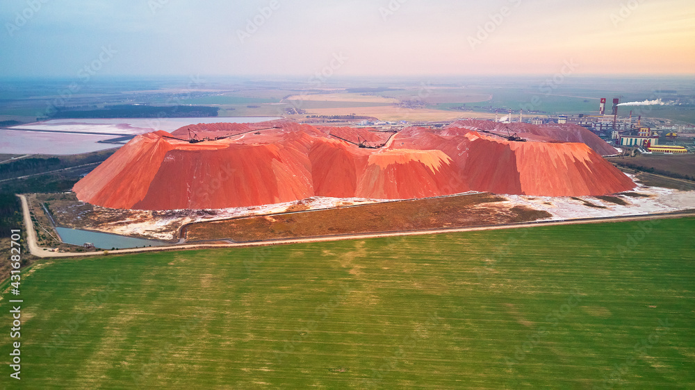Extracting mining potassium, magnesium salts minerals. Large excavator machine, mountains of waste ore. Belarus, Soligorsk