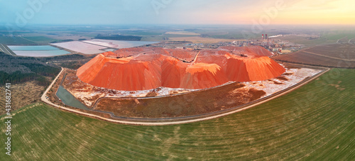 Fertilizer industrial plant. Artificial hills of dumps in production of potash. Ecology problem panoramic aerial view. Extracting mining potassium, mountains of waste ore