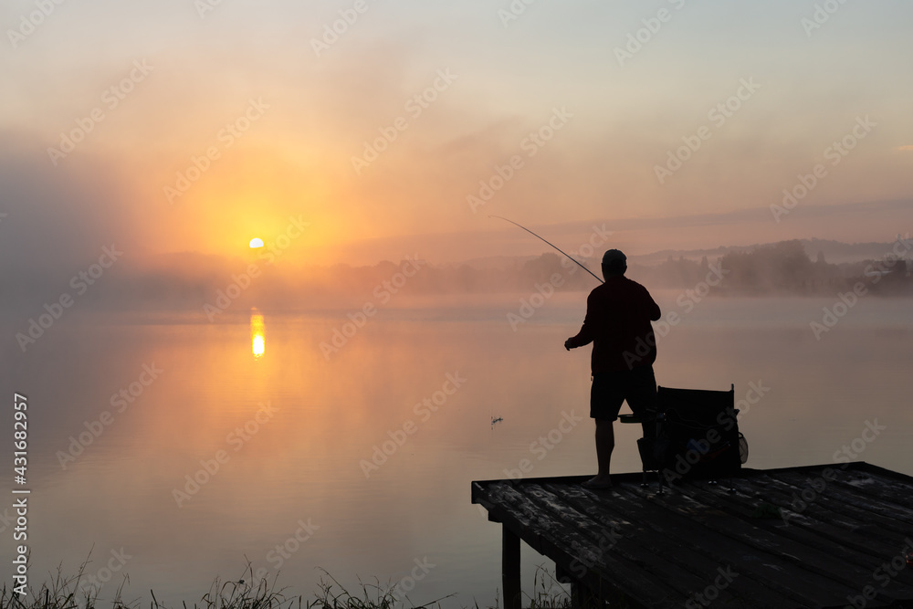 Fishing at dawn A fisherman throws a fishing rod. Summer rest Fishing at dawn A fisherman throws a fishing rod. Summer rest