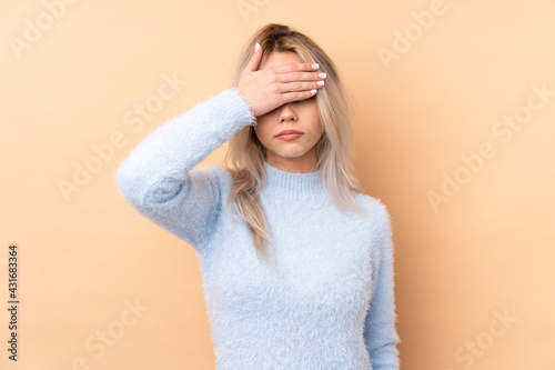 Teenager girl over isolated background covering eyes by hands