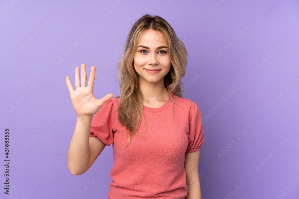 Fototapeta premium Teenager Russian girl isolated on purple background counting five with fingers