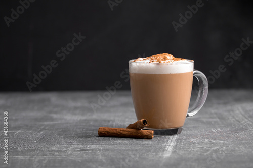 Homemade coffee latte cappuccino in a glass mug on the grey background