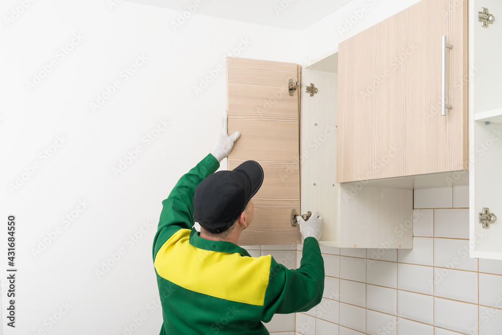 furniture assembly specialist hangs the fronts on the kitchen cabinet furniture assembly specialist hangs the fronts on the kitchen cabinet