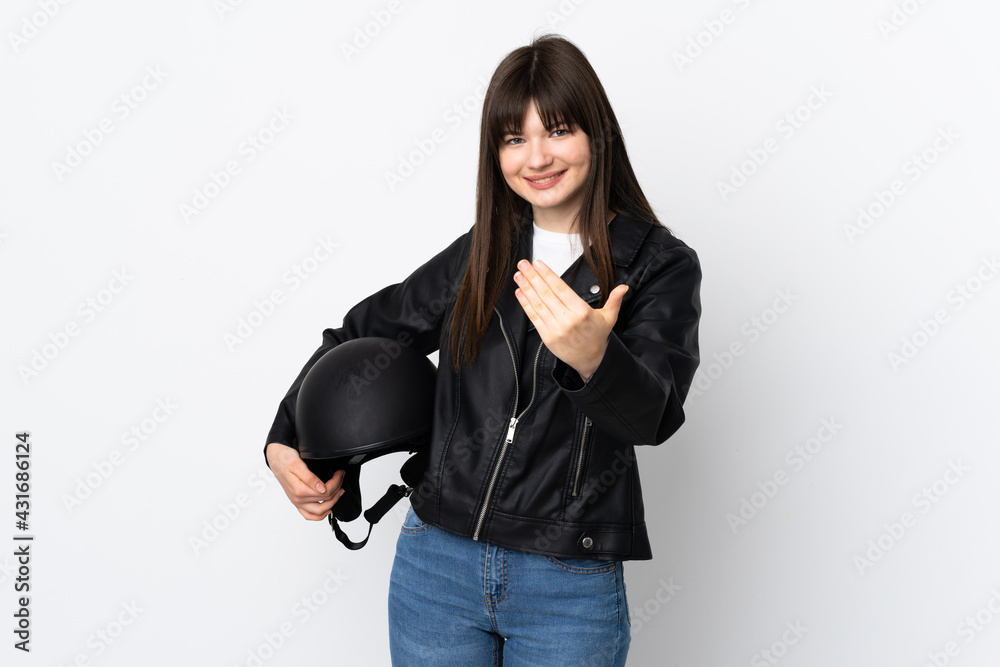 Woman holding a motorcycle helmet isolated on white background inviting to come Woman holding a motorcycle helmet isolated on white background inviting to come