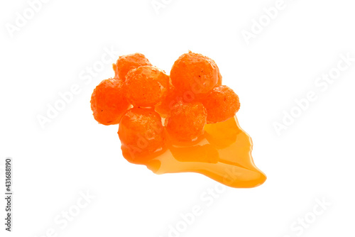 Close up view of orange boilies in dip, fishing baits for carp isolated on white background
