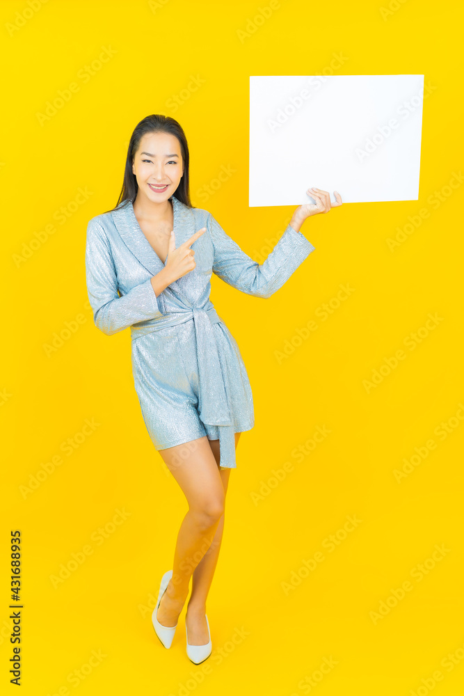 Portrait beautiful young asian woman smile with empty white billboard Portrait beautiful young asian woman smile with empty white billboard