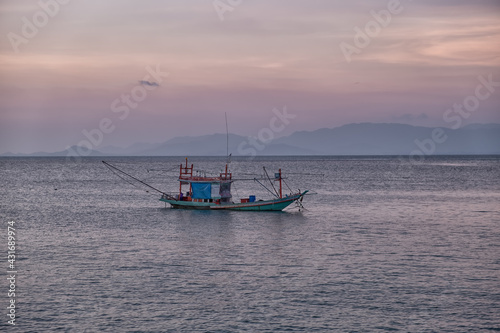 fishing boats at sunset