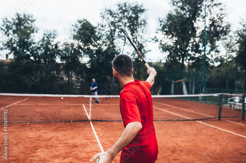man playing tennis on clay court