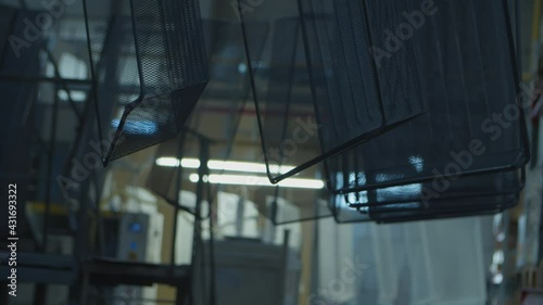 Wired mesh cages moving on the track in the factory