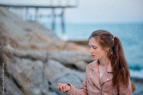 Garmony meditation, girl hand picking up heart from stones, relaxed hobby rest near sea