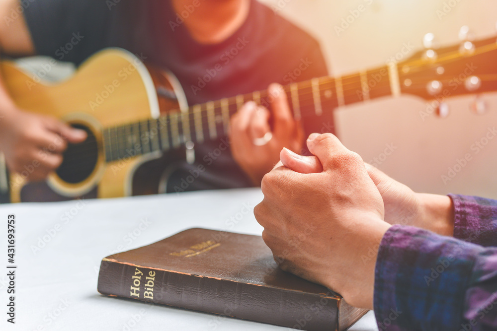Christian family worship God in home, with a guitar and the Holy Bible. praise and worship concept - obrazy, fototapety, plakaty 