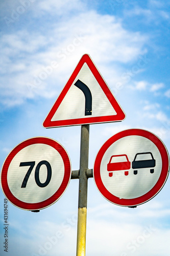 road sign overtaking is prohibited. road sign speed limit 70 km h. road sign turn right