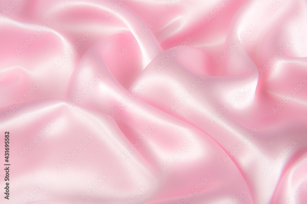 Obraz premium Abstract pink silk fabric texture background. Cloth soft wave. Creases of satin